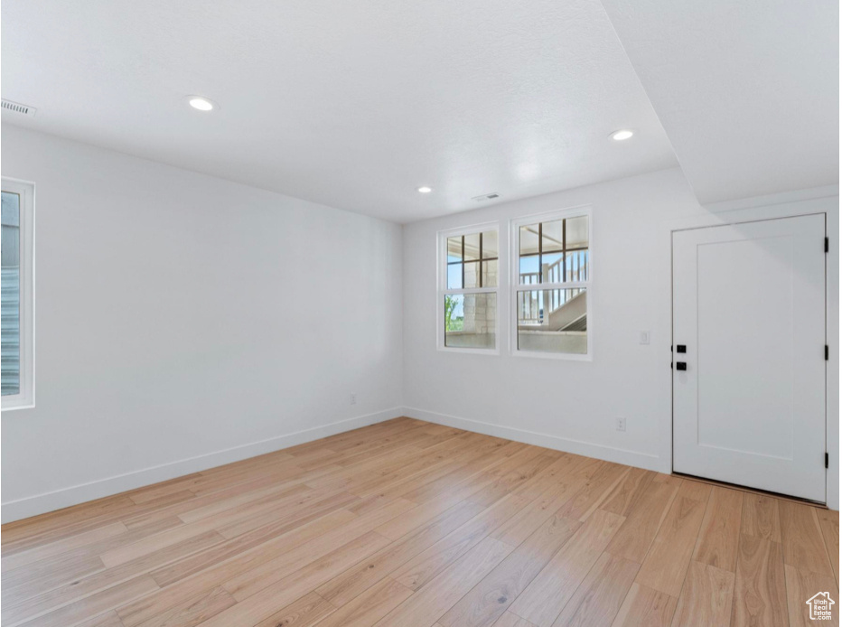 Interior space with recessed lighting, baseboards, visible vents, and light wood-style flooring
