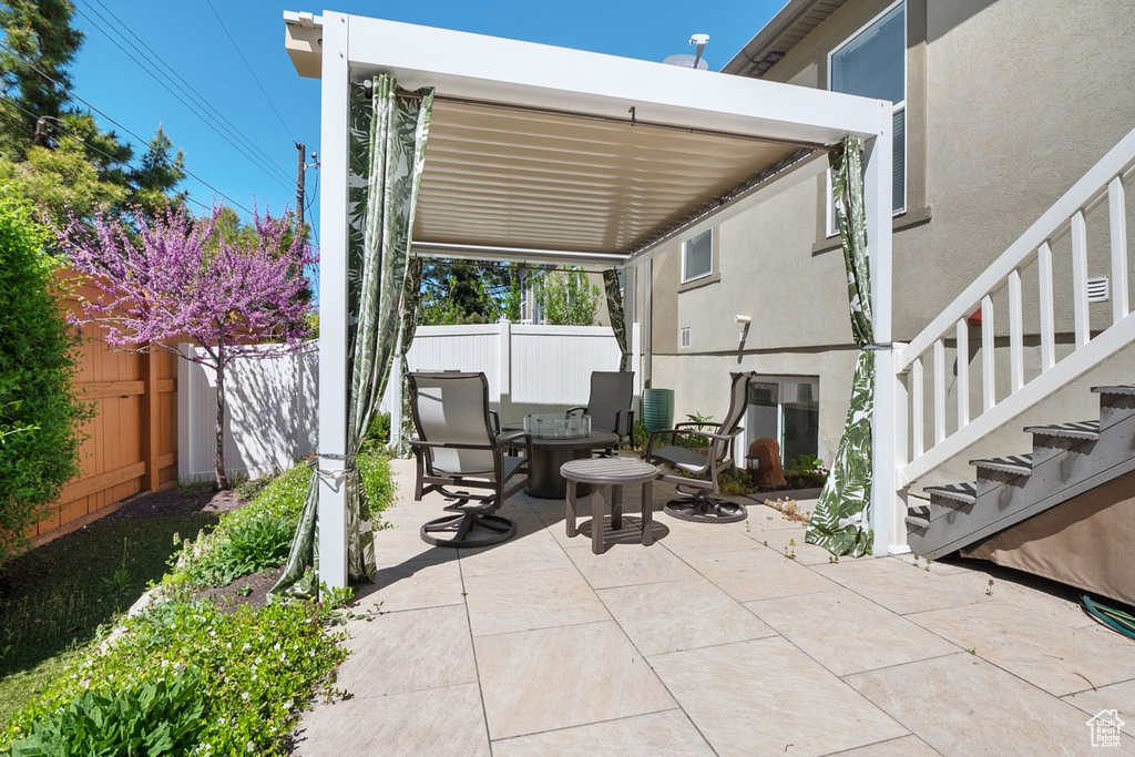 View of patio / terrace with fence and stairs