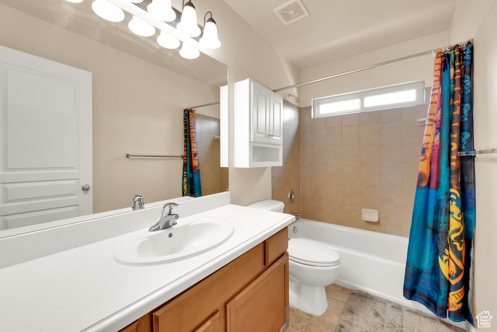 Bathroom with visible vents, tile patterned flooring, vanity, toilet, and shower / tub combo
