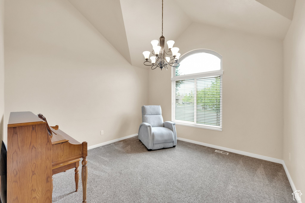 Sitting room featuring visible vents, carpet floors, a chandelier, and vaulted ceiling