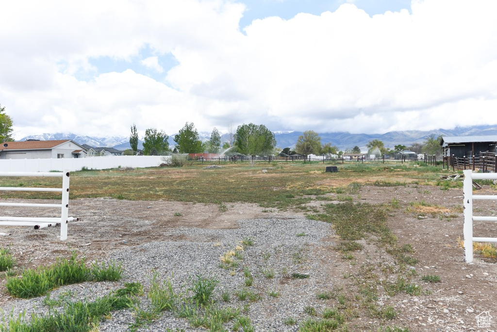 View of yard featuring fence and a mountain view