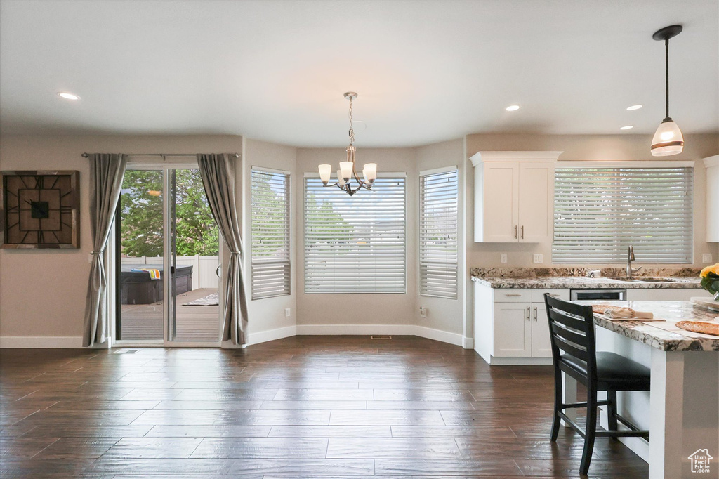 Kitchen with recessed lighting, baseboards, dark wood-style flooring, and white cabinetry