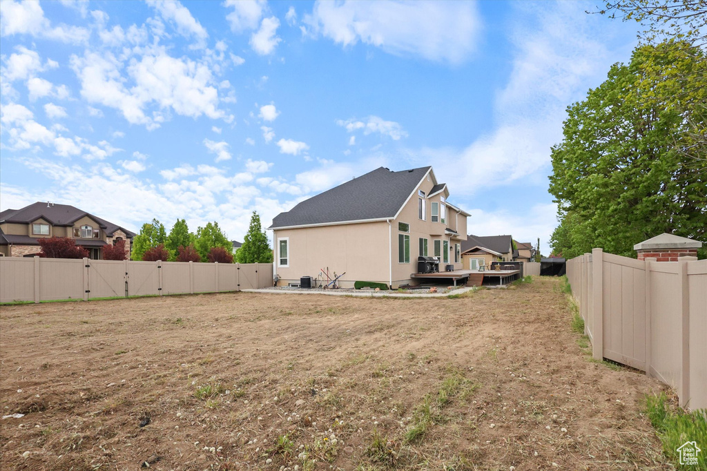 View of yard featuring a fenced backyard and a gate