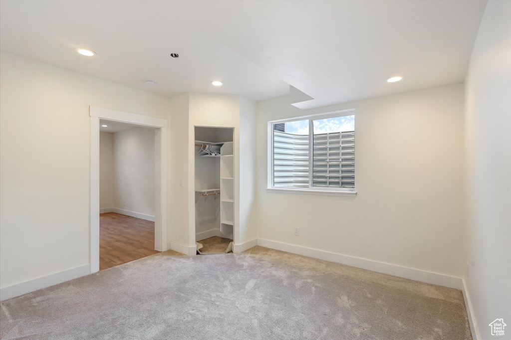Unfurnished bedroom featuring carpet floors, baseboards, and recessed lighting