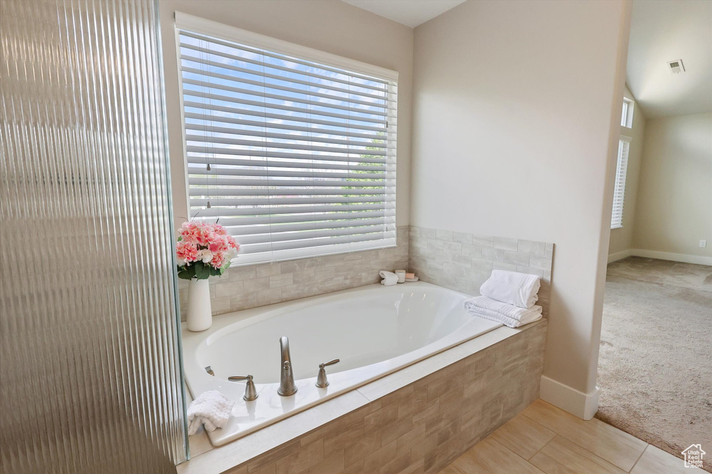Full bathroom featuring baseboards, a bath, and visible vents