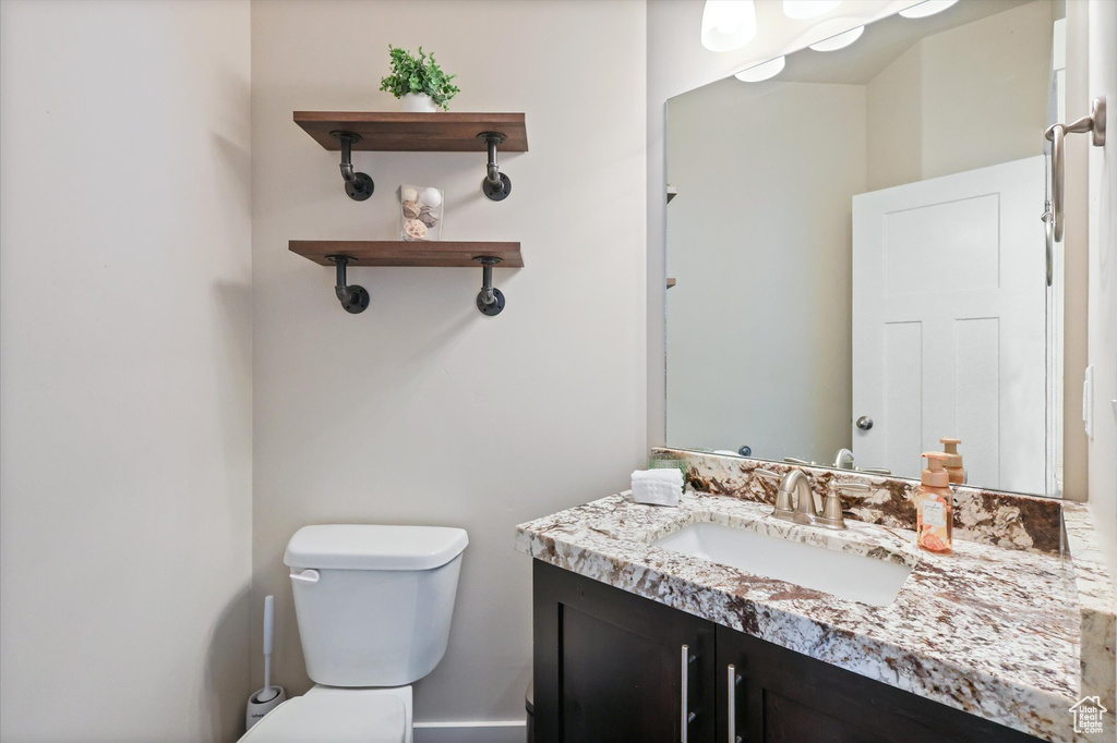 Half bathroom with toilet and vanity