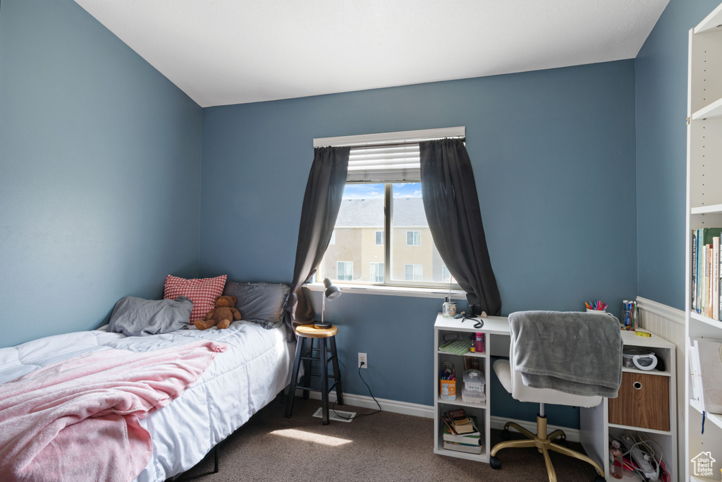 Bedroom with carpet floors and baseboards
