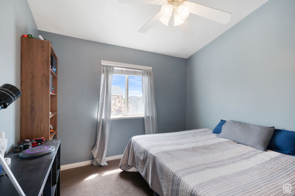 Carpeted bedroom with baseboards and a ceiling fan