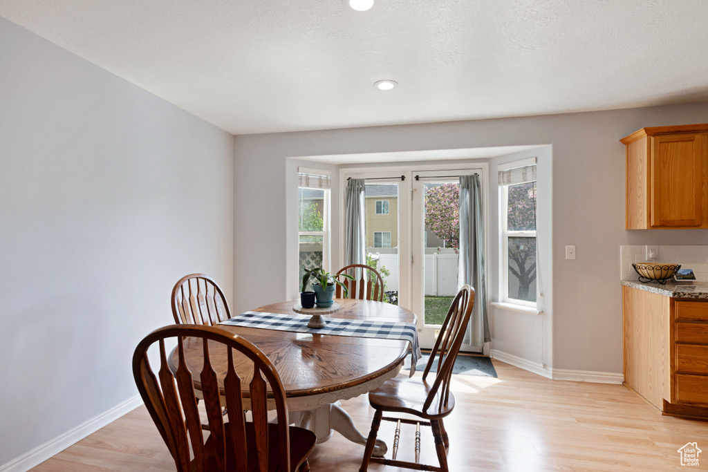 Dining area featuring recessed lighting, baseboards, and light wood-type flooring