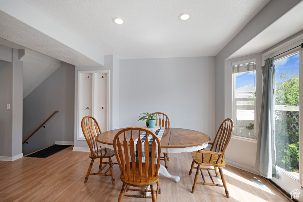 Dining area featuring baseboards, recessed lighting, light wood-style flooring, and a healthy amount of sunlight