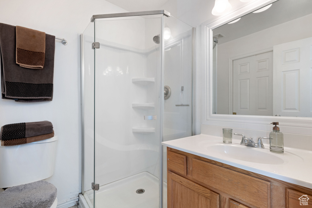 Full bath with vanity and a stall shower