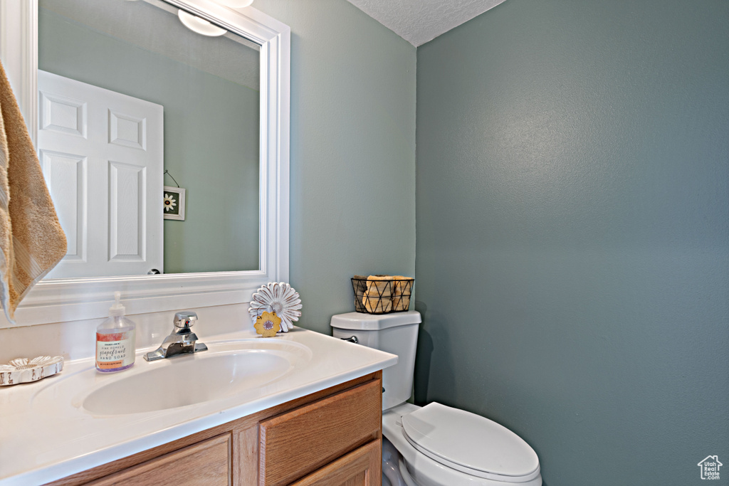 Half bath with vanity and toilet