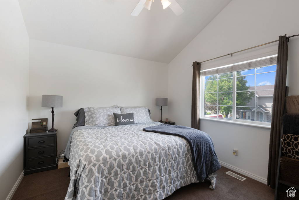 Bedroom with vaulted ceiling, baseboards, carpet flooring, and visible vents
