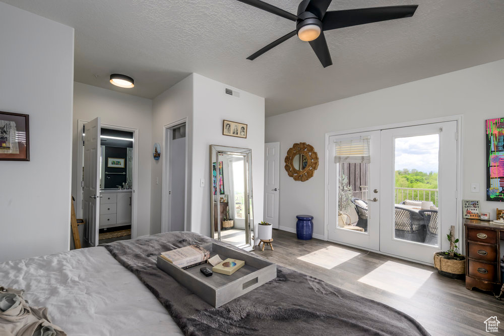 Bedroom featuring ceiling fan, french doors, visible vents, access to exterior, and wood finished floors