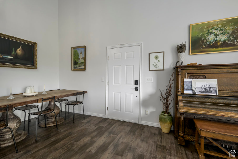 Foyer with baseboards and dark wood-type flooring