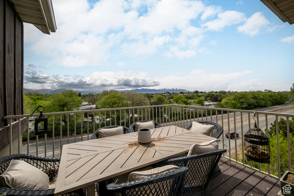 Balcony with outdoor dining area and a mountain view
