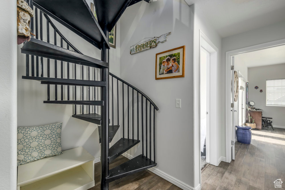 Staircase featuring baseboards and wood finished floors