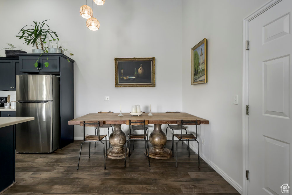 Dining room with baseboards and dark wood-type flooring