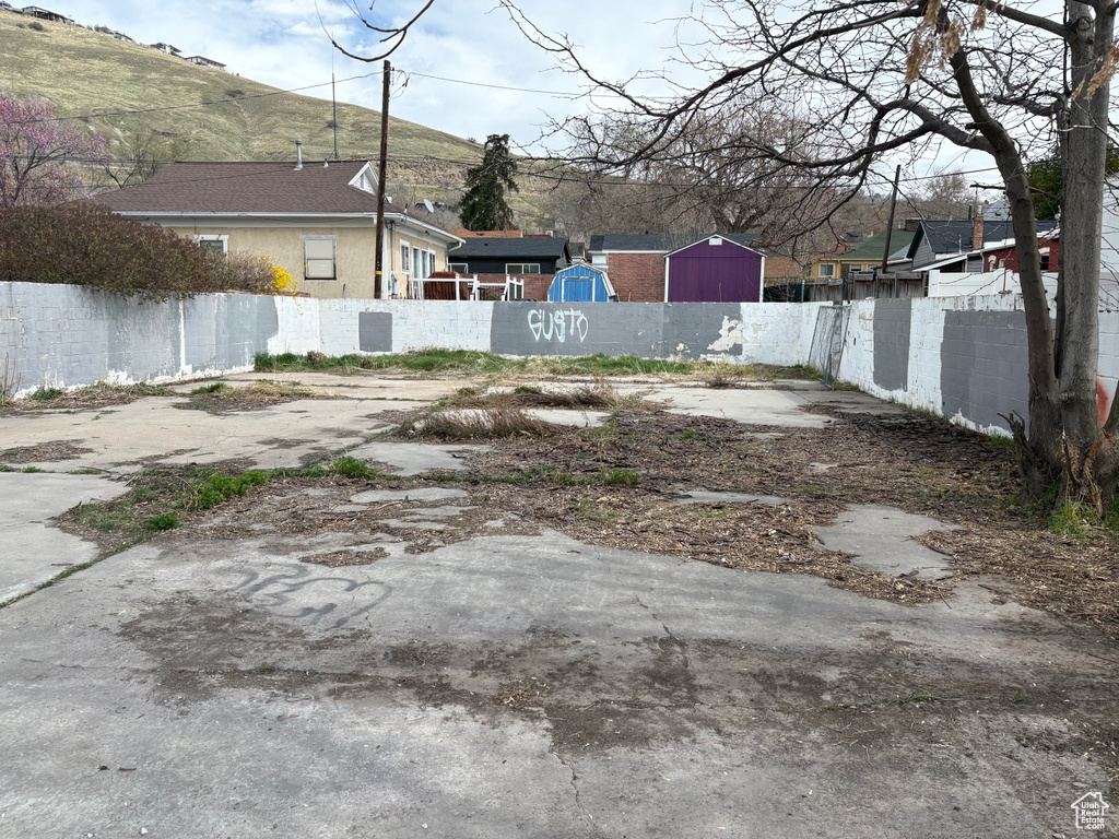 View of yard with fence and a mountain view