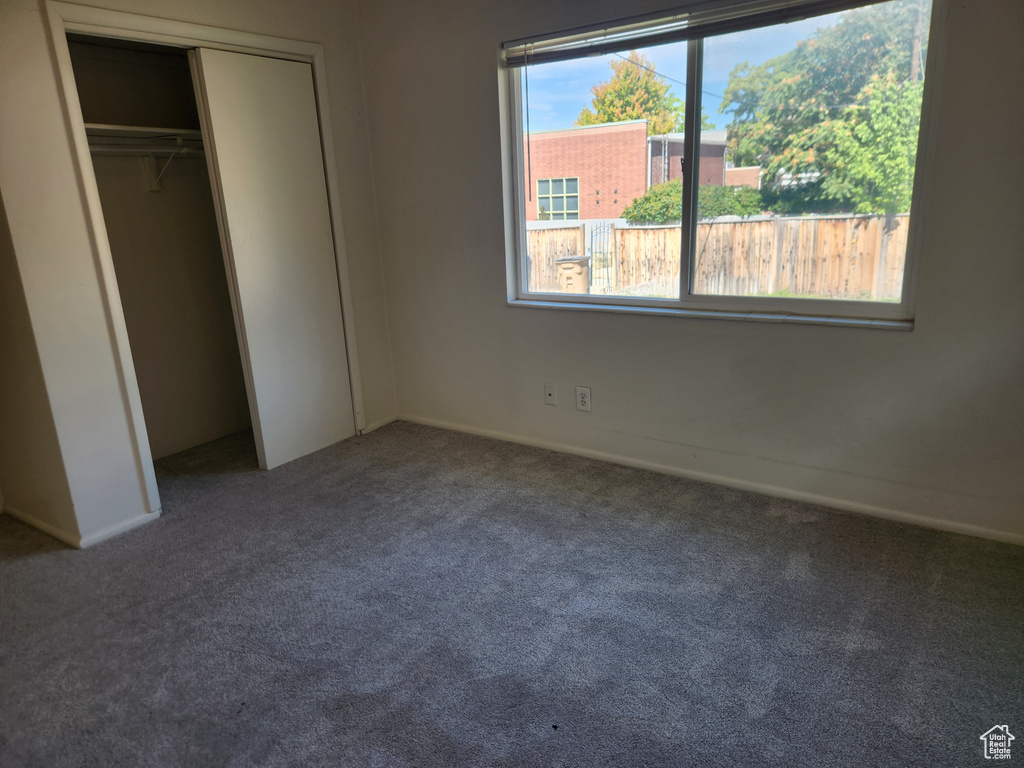 Unfurnished bedroom featuring a closet and carpet floors