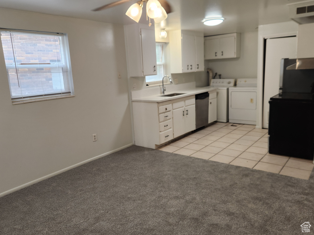 Kitchen featuring visible vents, a sink, separate washer and dryer, stainless steel dishwasher, and light colored carpet