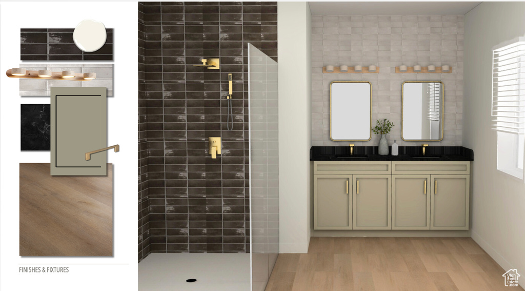 Bathroom featuring tiled shower, a sink, and wood finished floors