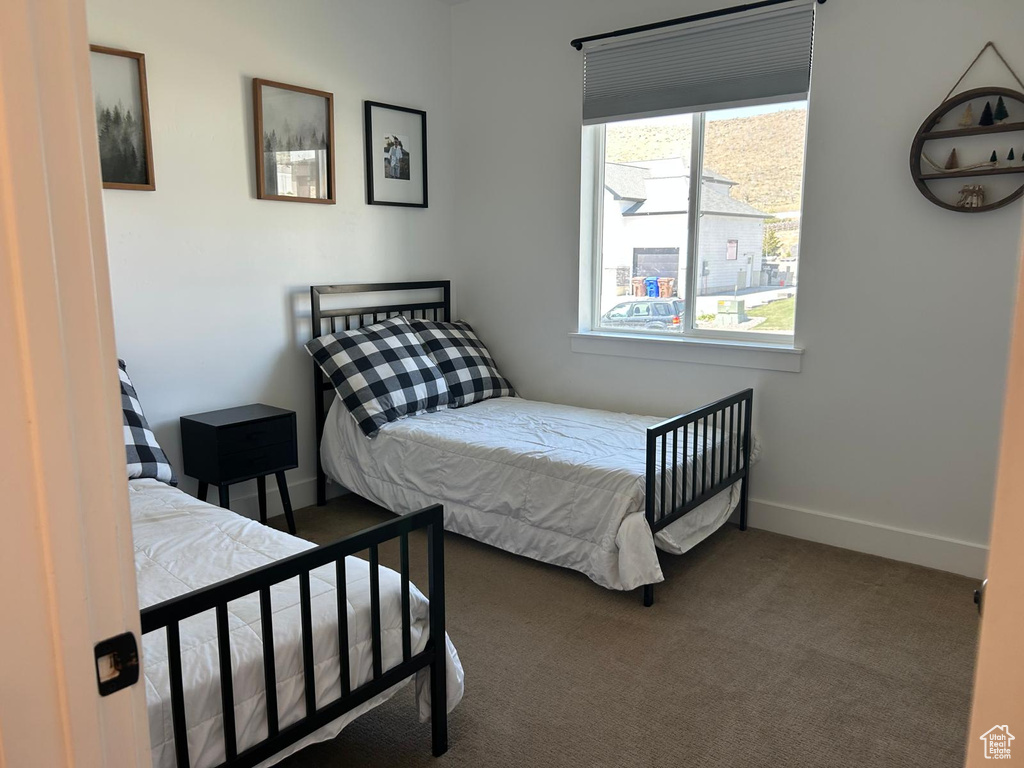 Bedroom with baseboards and carpet flooring