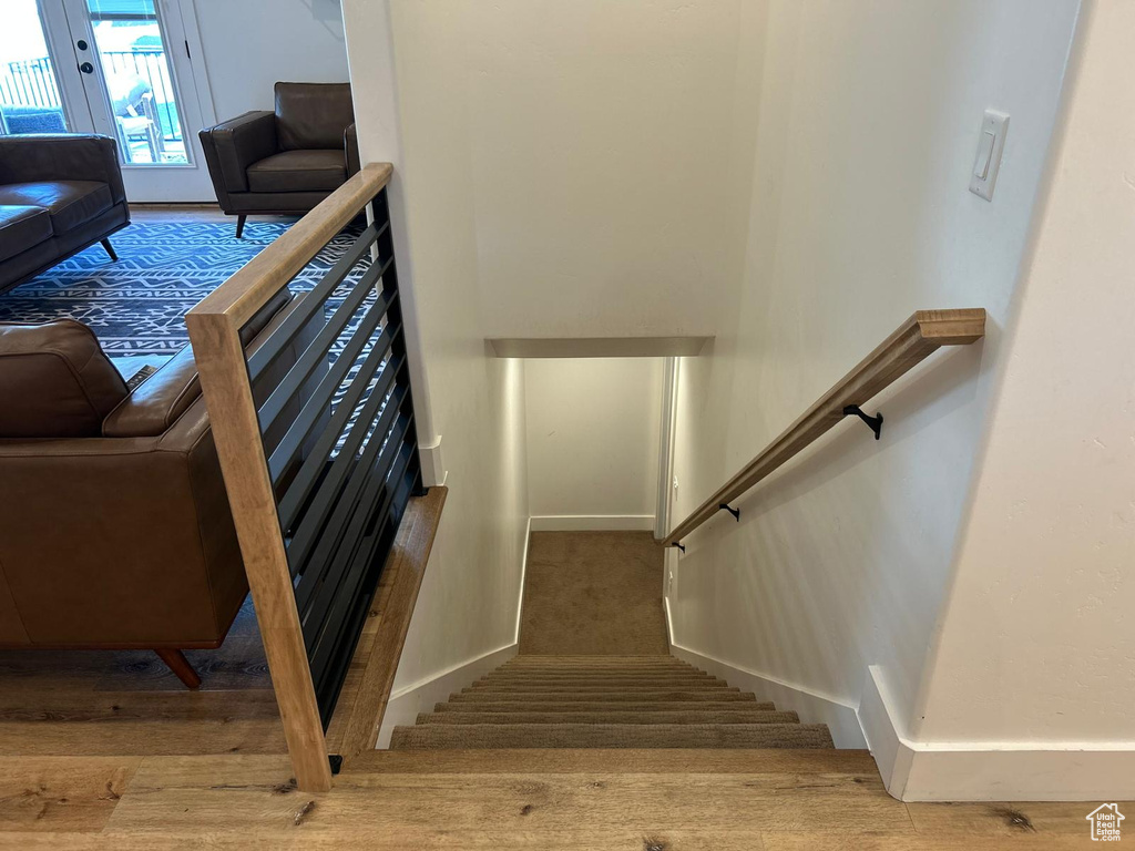 Stairs featuring baseboards and wood finished floors