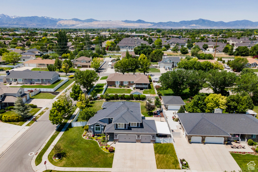 Aerial view of residential area featuring a mountainous background