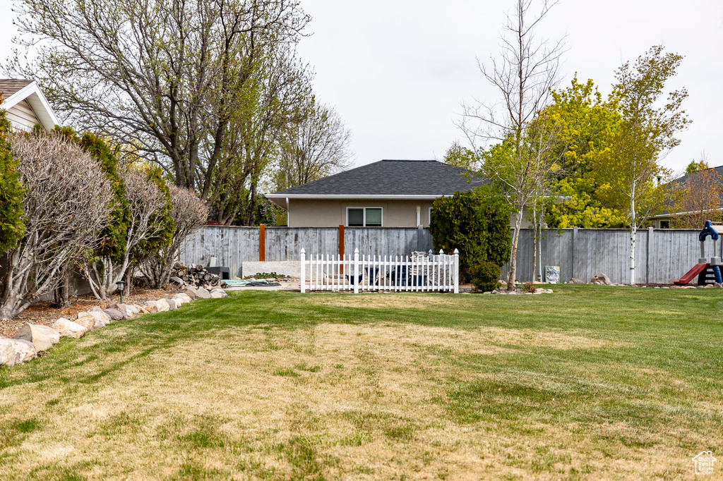 View of yard featuring fence and a playground