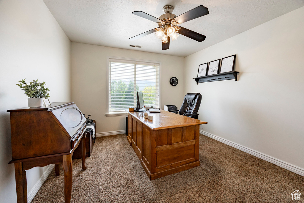 Office featuring light colored carpet, ceiling fan, and baseboards