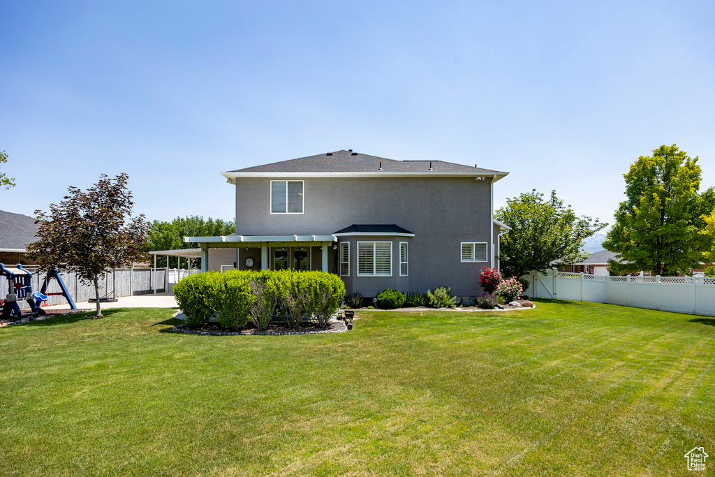 Back of property featuring a patio area and stucco siding