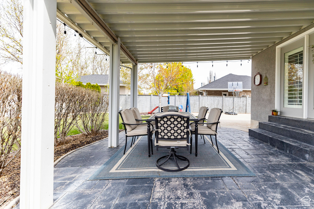 View of patio / terrace with outdoor dining area, a fenced backyard, and entry steps