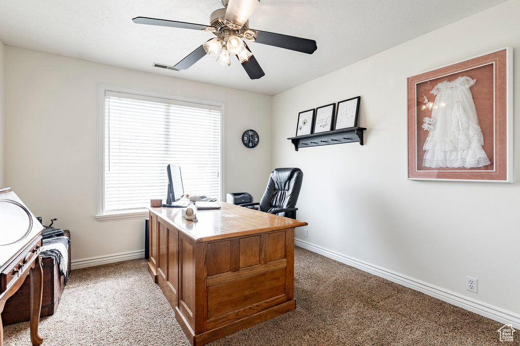 Office with a ceiling fan, baseboards, visible vents, and carpet