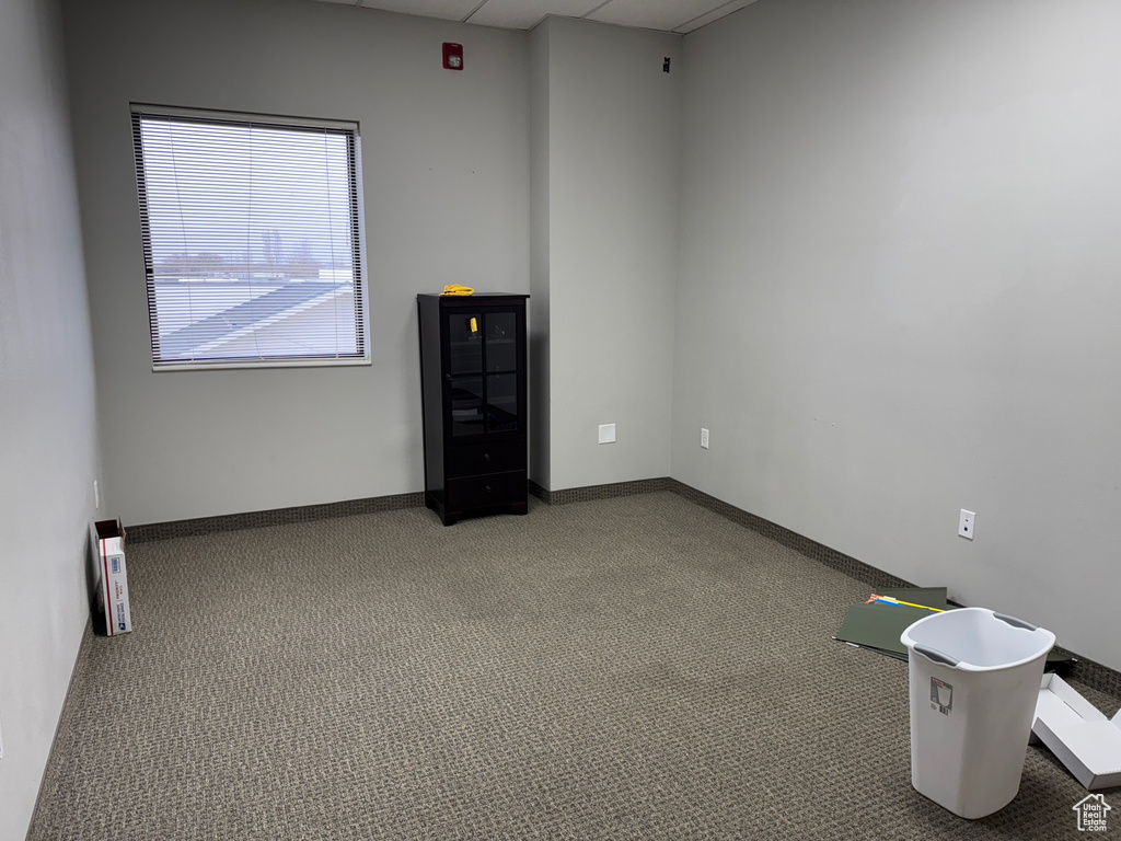 Carpeted empty room featuring baseboards