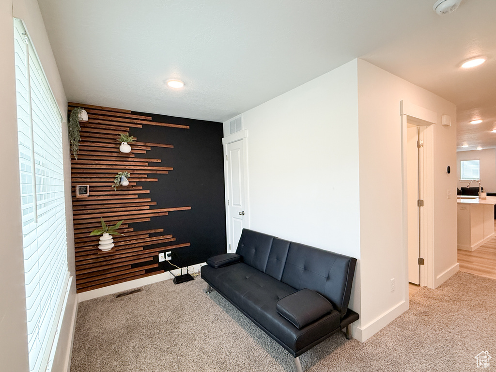 Sitting room with baseboards, carpet flooring, recessed lighting, and visible vents