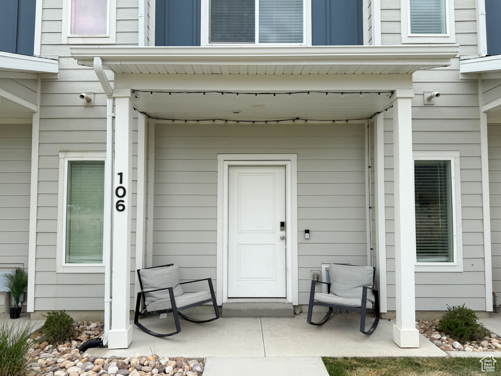 View of exterior entry with covered porch