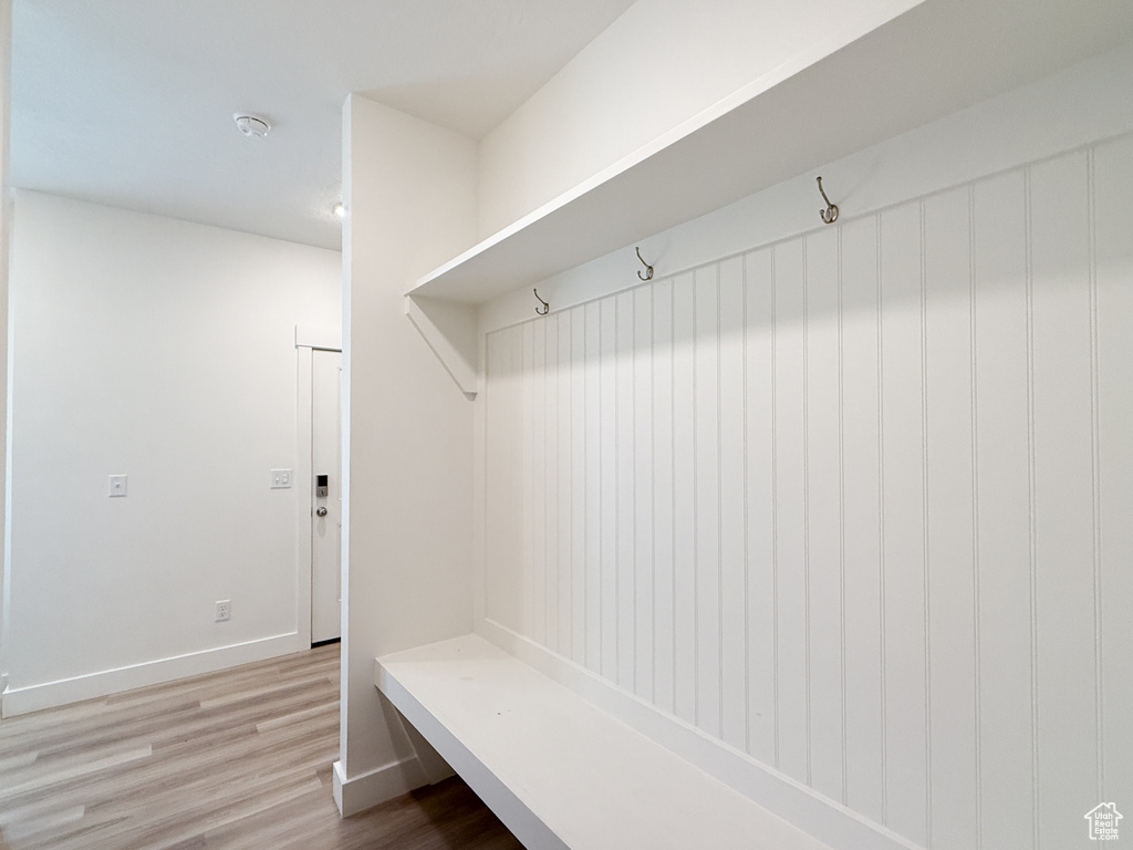 Mudroom with baseboards and wood finished floors