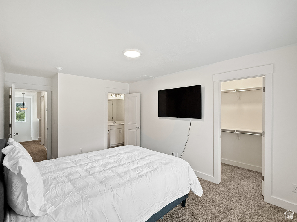 Bedroom with carpet floors, baseboards, a walk in closet, and a closet