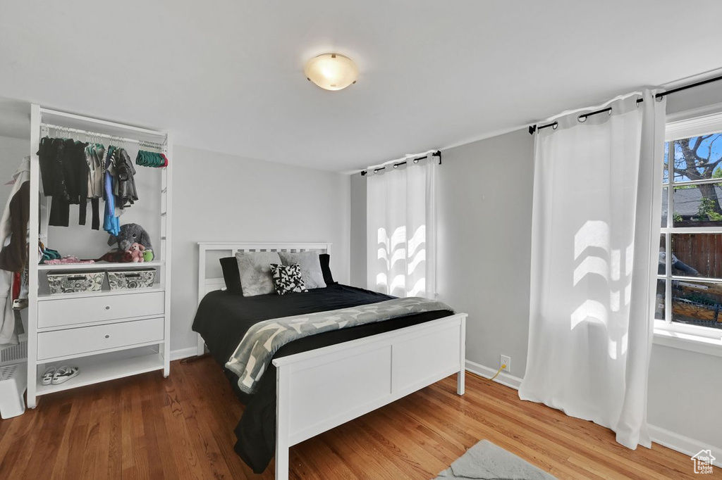 Bedroom featuring baseboards and wood finished floors