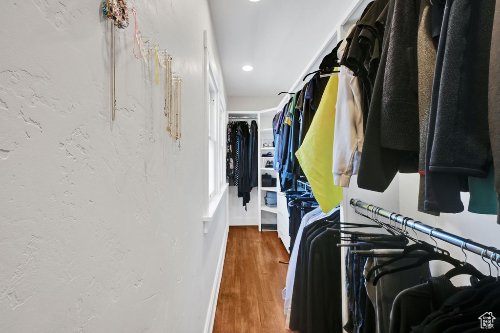 Walk in closet with wood finished floors
