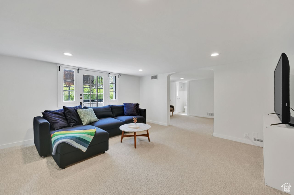 Living area featuring carpet floors, recessed lighting, baseboards, and visible vents