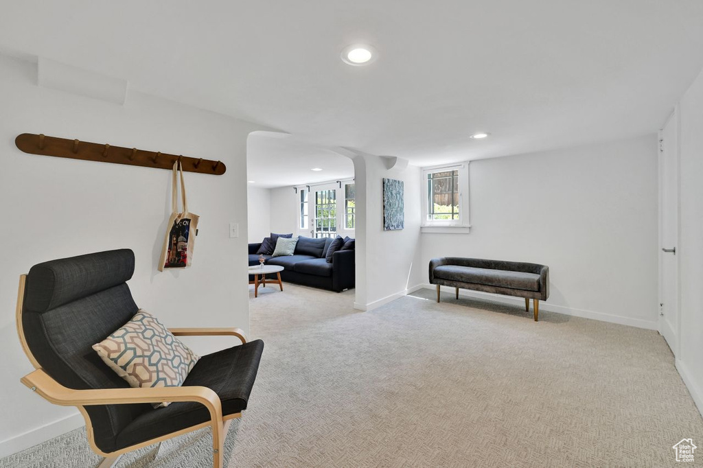 Living area with recessed lighting, baseboards, and light carpet