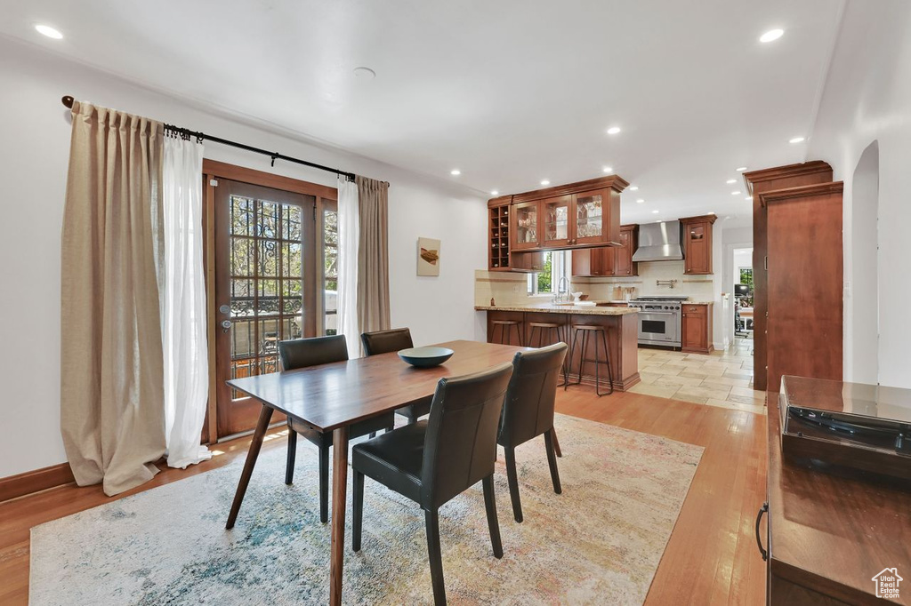 Dining space featuring light wood-type flooring, recessed lighting, and a wealth of natural light