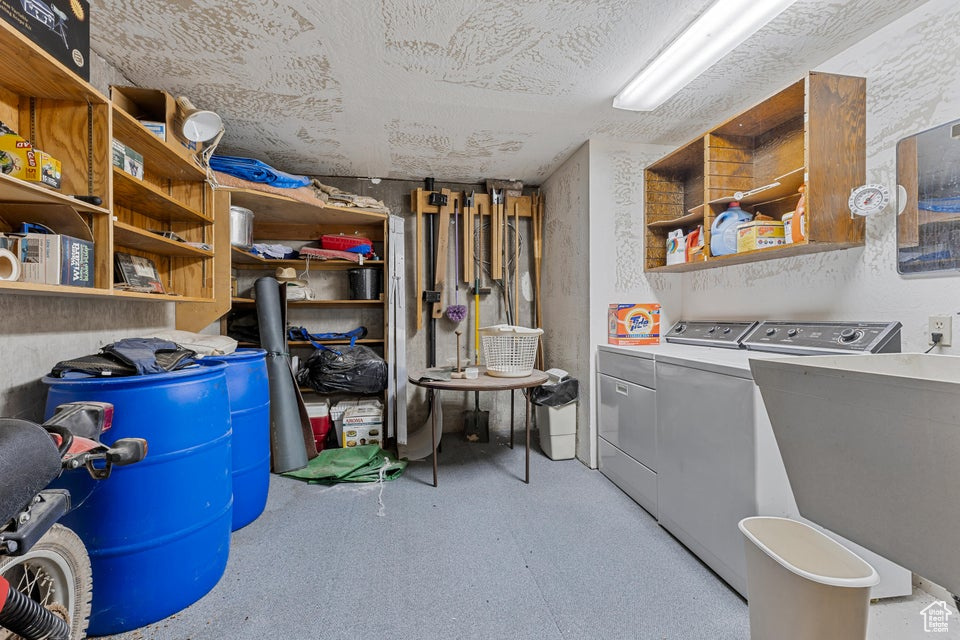 Laundry area with a sink and washing machine and dryer