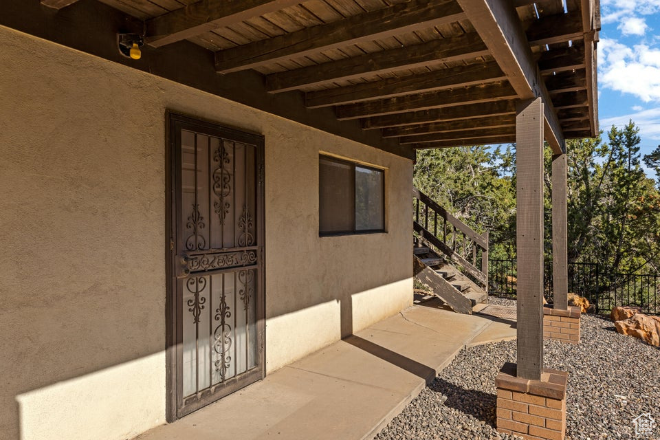 View of patio with fence and stairs