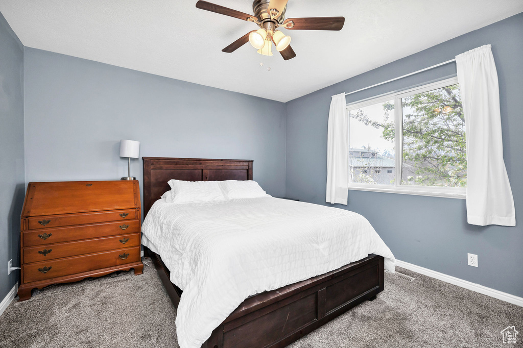 Bedroom with baseboards, a ceiling fan, and carpet flooring