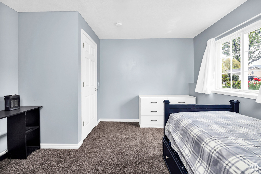 Bedroom featuring baseboards and carpet