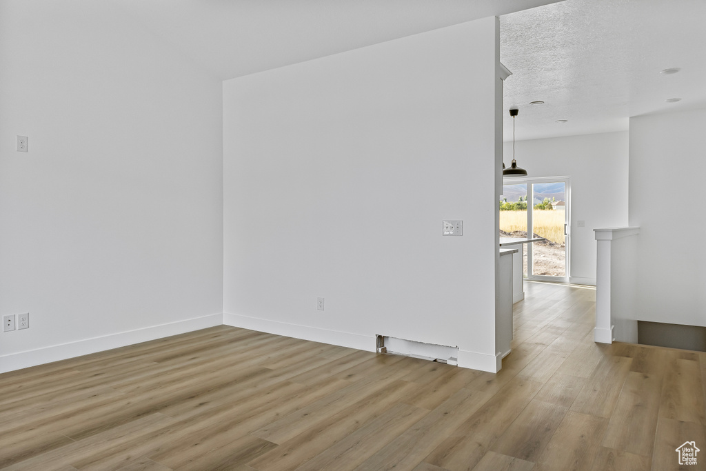 Empty room featuring light wood-style flooring and baseboards