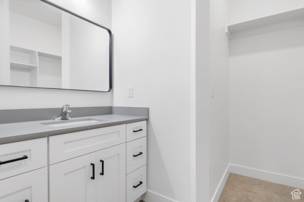 Bathroom featuring baseboards and vanity